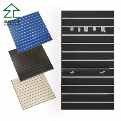 China Slatwall MDF Slotted Board /15mm 18mm PVC Surface Slot Slat Wall Panel with Metal Hooks for sale