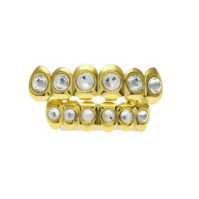 China Cheapest Price Hiphop Gold Color Teeth Grillz Top And Bottom Grill Set With Big Round Diamond Copper Dental Grillz Set for sale