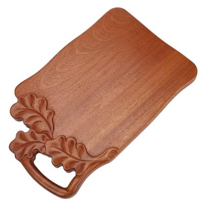 China Sustainable Premium Engraving Design Sheet Ebony Wooden Cutting Board With Handle Chopper for sale