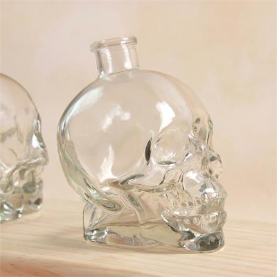 China Amazon Skull Hot Sale 180ml 6oz Skull Shape Tequila Shot Glass Clear Whiskey Glass Bottle With Wood Stopper for sale