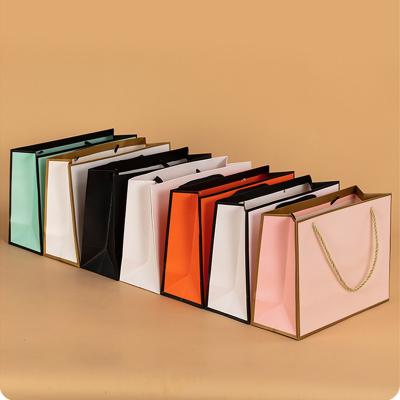 China Recyclable Wholesale Custom Printed Gift Luxury Shopping Paper Bag With Handle for sale