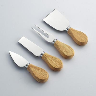 China Sustainable Rubber Wood Handles Cheese Knife With PET Tray Stainless Steel Kitchen Cheese Tools for sale