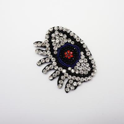 China Sustainable Fashion Custom Rhinestone Pearl Eye Embroidery Patches For Apparel for sale