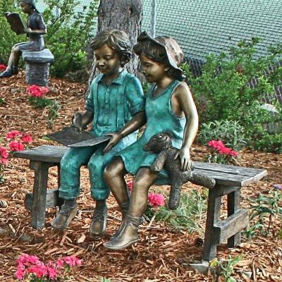 China Europe Outdoor Decoration Bronze Boy And Girl Reading Book On The Beach Statue BFS-B062W for sale