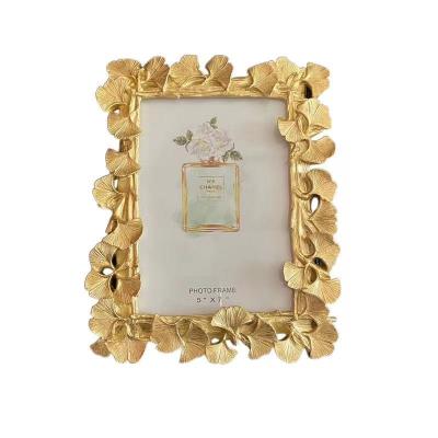 China Resin + glass creative high efficiency household gold photo frame desktop photo frame decoration for sale