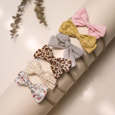 China Eco-freindly bow hair bands baby supply a variety of styles wholesale baby tide sheet is tasted for sale