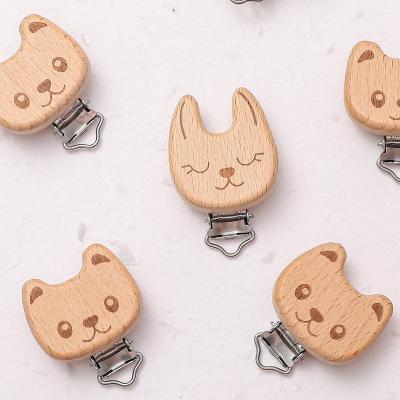 China 100%food grade silicone new beech wood and metal material pacifier clip natural animal babies can bite with pacifier clip for sale