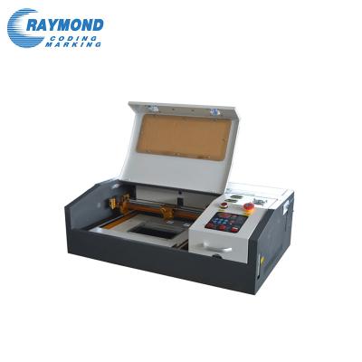 China Laser Engraving Raymond 3020 Mini Best Quality 50W 6040 CO2 Tube Laser Engraving Machine for sale