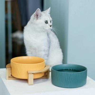 China Customized Nordic Embossed Ceramic Stocked Matte Cat Dog Food Bowl Elevated Pet Bowl With Wooden Stand for sale