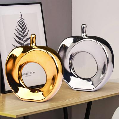 China Modern creative ceramic gold and silver apple hollow ornaments decorations Nordic modern home office opens Christmas arts figurines for sale