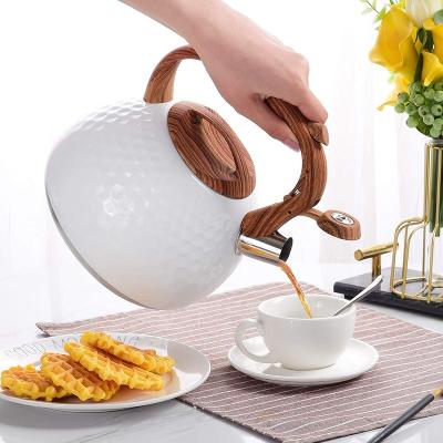 China Stored Top Stove Stainless Steel Tea Kettle Whistling Teapot With Wooden Pattern Handle Whistling Tea Kettle for sale