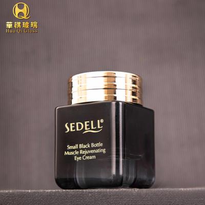 China Luxury Glass Bottles Gold Face Cream Cosmetic Jars Black Glass Bottle 50g Empty Bottles Skin Care With Lids for sale