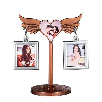 China Home Decoration Angel Memorial Photo Stand Ornaments of Home Decoration White Metal Alloy Painting Frame for sale