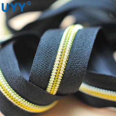 China Custom Nylon Gold Tooth UYY 3# Zipper Roll Gold Long Chain Nylon Teeth Zippers for sale