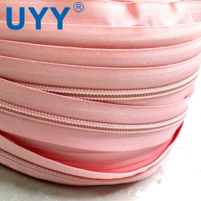 China UYY Pink 5# Durable High Quality Long Chain Nylon Zipper Roll For Bulk Orders for sale