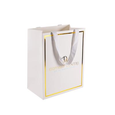 China Recyclable Custom Luxury Clothing Packing Retail White Paper Bag Card Gold Foil Shopping Gift Bag With Cotton Handle for sale