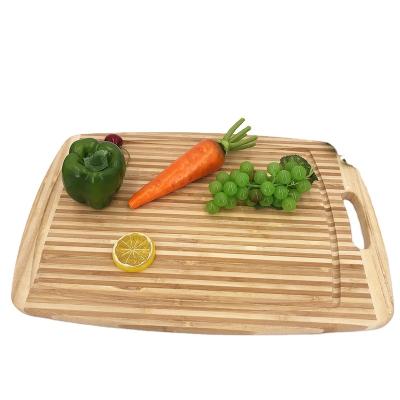 China Personalized Sustainable Bamboo Stripe Fruit Groove Cutting Board With Handle for sale