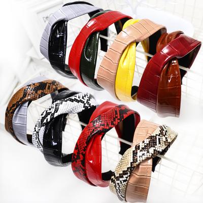 China Popular Animal Suede Leather Wide Snake Headband PU Cross Knotted Headband for sale