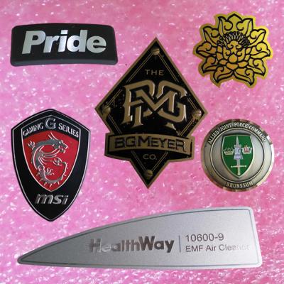 China Personalised Metal Pin Badges Casting Aluminum Embossed With Self Adhesive for sale