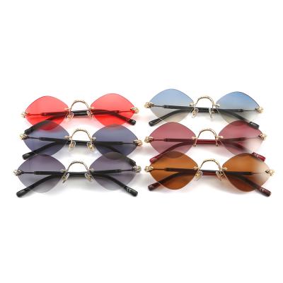 China Fashion Sunglasses Metal Frame Shape To Diamond ShapeLuxury Female Glasses 2021 Vintage Rimless Sunglasses for sale