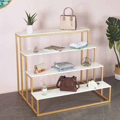 China Metal Floor Stepped Multilayer Stacking Storage Racks Supermarket Display Shelves - for sale