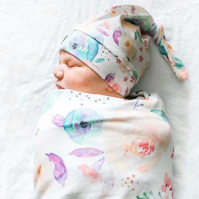 China Sage Newborn Swaddle Folded with Matching Knot Hat Top Organic Cotton Printed Baby Cocoon Wrap Wrap Set for sale