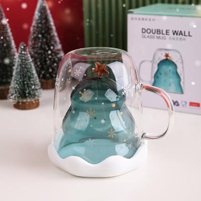 China Beautiful Sustainable 300ml Double Wall Glass Mugs Christmas Tree And New Design Star Shaped Coffee Milk Mug With Food Grade Silicone Lid for sale