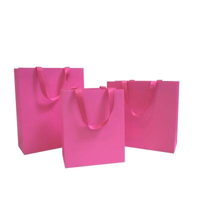 China Recycled Materials Gift Card Exquisite Pink Cardboard Printed Paper Bag for sale