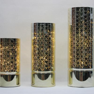 China Trendy glass led light home decoration cylinder lamp gold glass with warm white light and hearts laser cut for sale