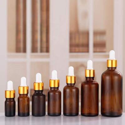 China 1oz Cosmetic Amber Glass Dropper Bottles with Eye Dropper and Gold Cap Perfume Sample Vials Essence Liquid Cosmetic Containers for sale