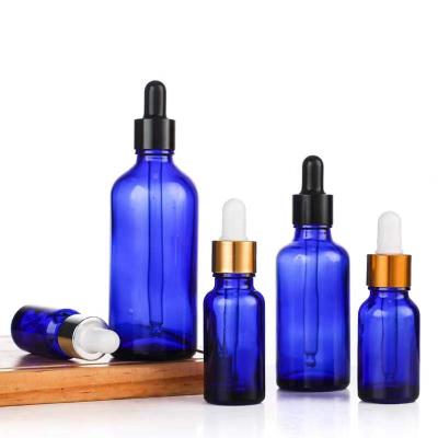 China Cosmetic 2oz Glass Dropper Bottle With Long Blue Glass Dropper 60ml Tincture Glass Bottles For Essential Oils Perfume Liquids for sale