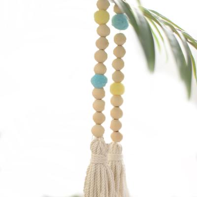 China New Decoration Plant Wooden Garland with Tassel Wall Hanging Decoration Decorative Wooden Beads for sale