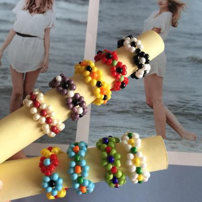 China 2021 Hot Selling Colorful Acrylic Environmentally Friendly CIA Ring Beaded Flowers Hand Woven Adjustable Elastic Handmade Ring For Women Gift Waterproof for sale