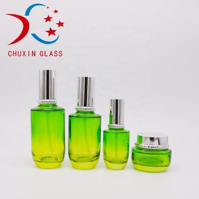 China Cosmetic shoulder essence toner face cream cleansing glass bottle silk cream jar green30ml 40ml 50ml 100ml 120ml for sale