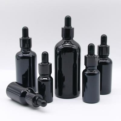 China Personal Care Cbd Packaging Essential Oil Bottle Black Frosted Bottle Glass for sale