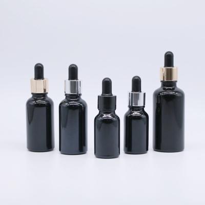 China 15ML Cosmetic Hot Luminous Black Fine Glass Oil Bottle 0.5oz Different Capacity Dropper Bottle for sale