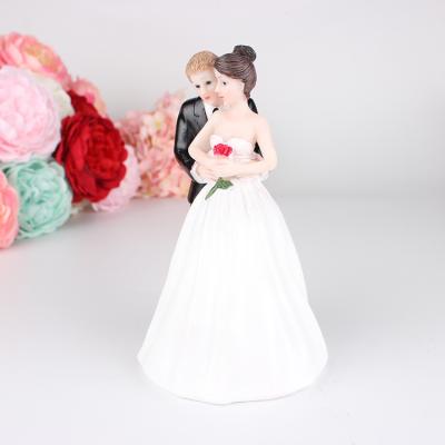 China Festival Decoration Selection Wedding Cake Dolls Embrace The Wedding Look Cake Decorations Resin Crafts For Bride And Groom for sale