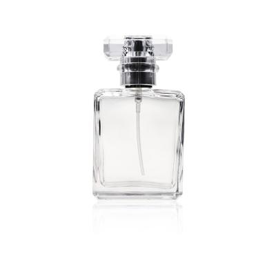 China Custom Brand Square Clear Logo Cosmetic Custom Original Crimp Glass Perfume Bottles 30ml 50ml 100ml With Clear Lids for sale