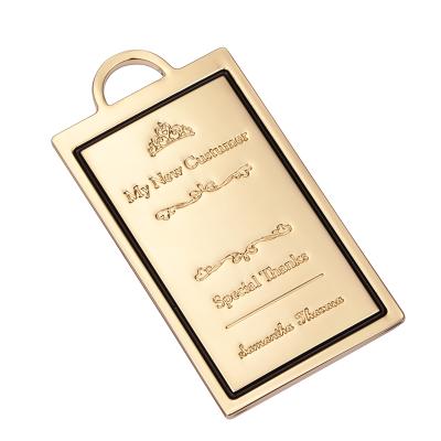 China Custom fashion accessories metal crown shape logo plate label gold metal brand tag for handbags for sale