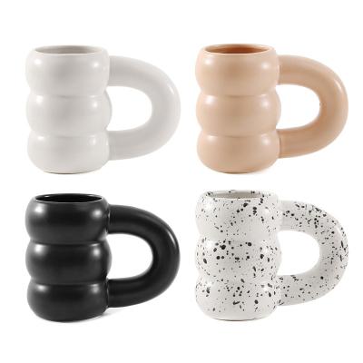 China Viable New Design Creative Irregular Ceramic Handle Solid Color Splash-ink Tire Mugs for sale