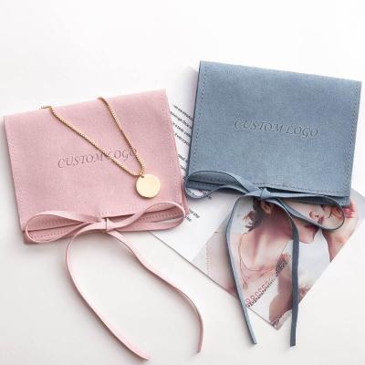 China Protect Jewelry Custom Fold Out Suede Jewelry Pouches Envelope Pink Microfiber Embossed Jewelry Pouch With Ribbon for sale