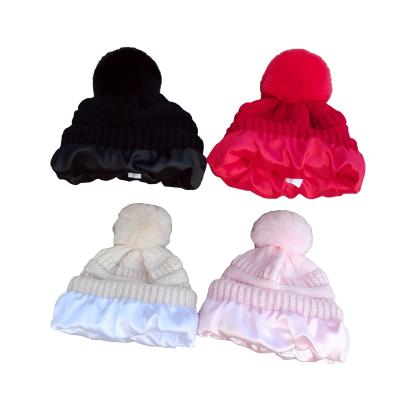 China Newest JOINT Popular Satin Lined Fluffy Pompom Knitted Hat Fashion Knitted Hat for sale