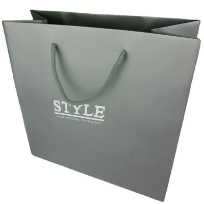 China Custom White Recyclable Silk Screen Printing Logo Good Quality Paper Bag With PP Rope Twine Handle In Silver Color Bag for sale