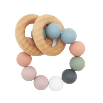 China Beech Toys First Rattle Toys Silicone Baby Teething Wrist Wooden Teether Wooden Soft Infant Educational Ring for sale