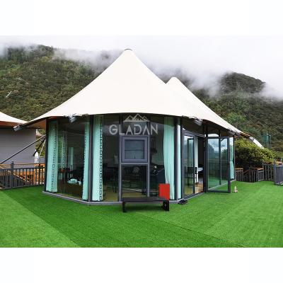 China GLADAN Soundproof Ready Prefab Hexagon 2 Peak Home Lush Glass Wall Tent Glamping Hotel With 1 Bedroom 1 Bathroom And Living Room for sale