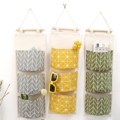 China Sustainable Creative Canvas Cotton Waterproof Three Pockets Wall Hanging Storage Bags Wall Home Household for sale