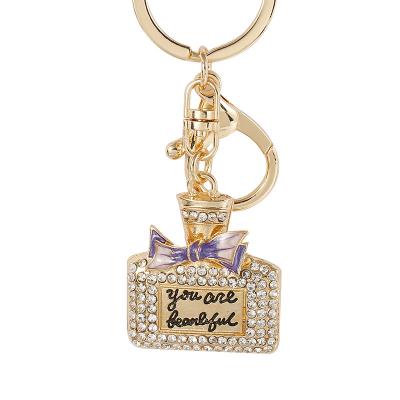 China Custom Creative Cute Metal Car Ornament Key Chain Perfume Bottle Key Chain New for sale