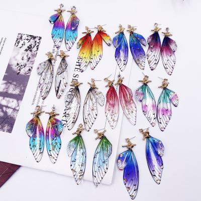 China TRENDY Hot Sale Gradient Rainbow Resin Wings Drop Earrings For Women Bowknot Rhinestone Butterfly Gold Knotted Earring for sale