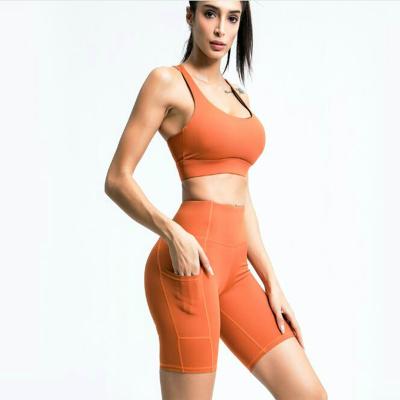 China Solid Color Breathable Nylon High Elastic Sports Bra+Short Pants Fashion Daily Sports Wear Set With Pocket for sale