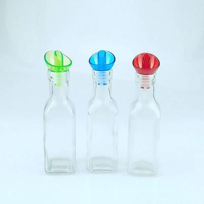 China Freshness Preservation 200ml Glass Cooking Oil Bottle With Plastic Pourer Lid for sale